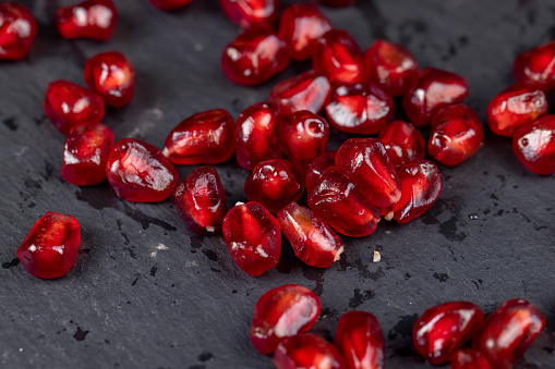 peeled red ripe pomegranate with red sweet grains, juicy pomegranate seeds of red color