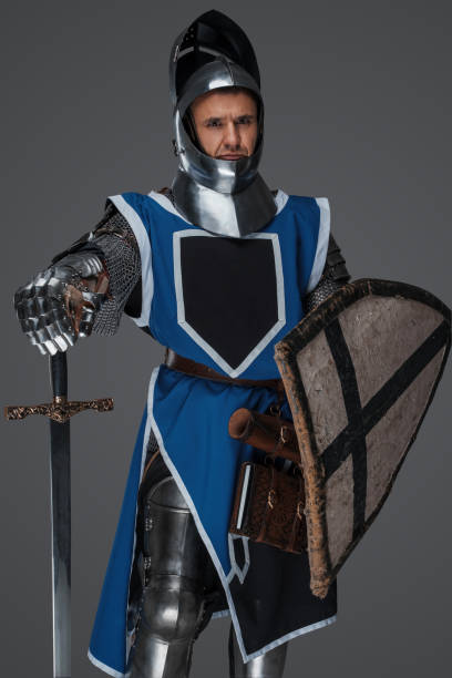 istock Valiant medieval warrior wearing armor and blue surcoat 1606834066