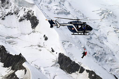 Climber being airlifted by helicopter near Pic du Midi in Mont Blanc mountain range on August 31, 2023