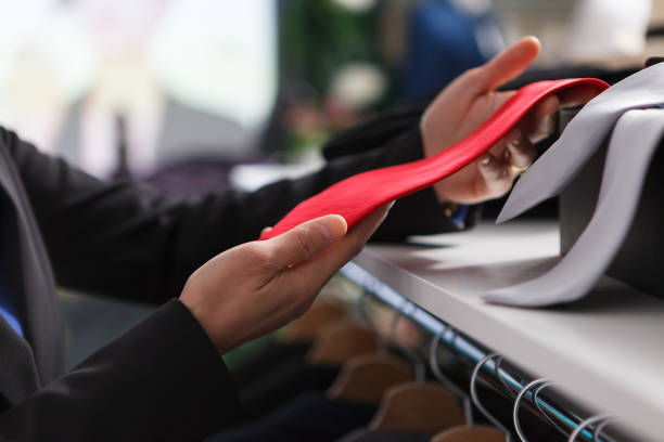 istock Store employee holding red tie closeup 1606881628