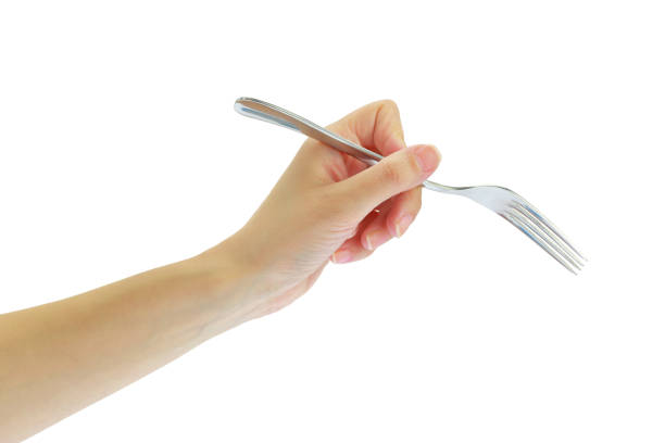 istock Female hand holding a fork isolated on white transparent background 1606891186