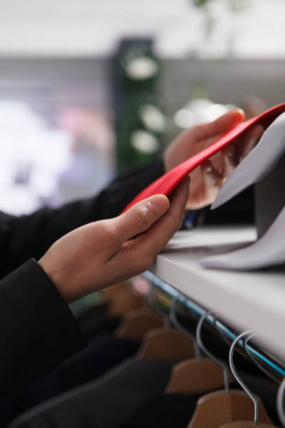 istock Seller hands adjusting red tie closeup 1606896398