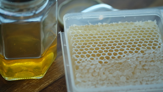 A honeycomb is a mass of hexagonal prismatic cells built from wax by honey bees in their nests to contain their brood and stores of honey and pollen.