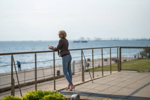 istock Businesswoman checking emails on mobile phone 1606915562