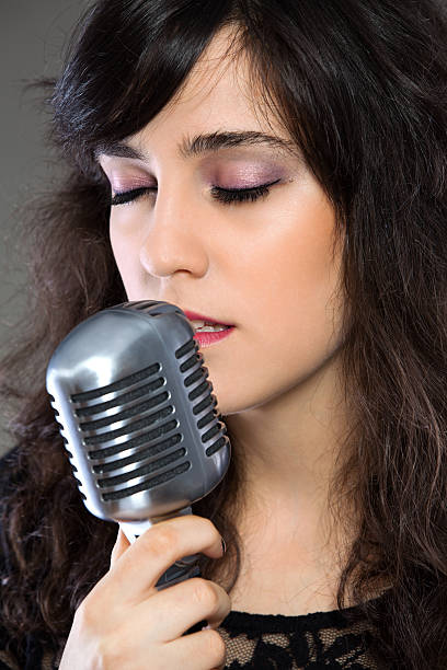 istock Attractive young  woman with a retro microphone 160692865