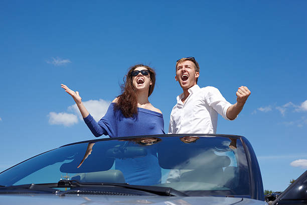 istock Young couple stands in cabriolet and shout 160695327