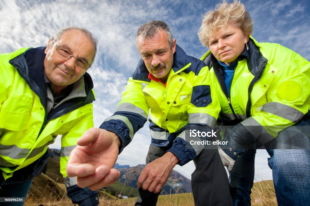 Swiss Paramedics Team Bending Over And Offer Help In Alps Swiss Paramedics Team Bending Over And Offer Help In Alps. Image captured in Lenk, Simmental, Bernese Oberland, Switzerland at Lenklypse 2012. 45-49 Years Stock Photo