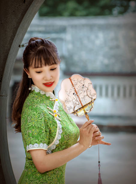 A beautiful woman in a qipao is performing a qipao show