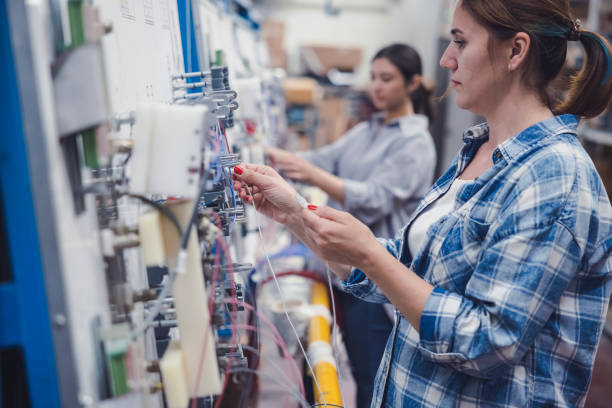 Young women working on the production line in factory stock photo