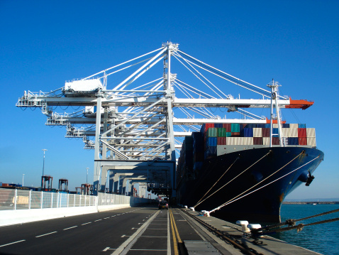 Huge cargo container ship at the commercial loading dock of Le Havre - the second largest French and the fifth largest North-European port.