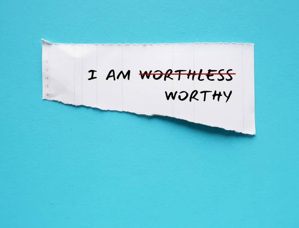 istock Torn white paper on copy space blue background with text I AM WORTHLESS change to I AM WORTHY, concept of self talk affirmation to build self esteem and acceptance 1607024032