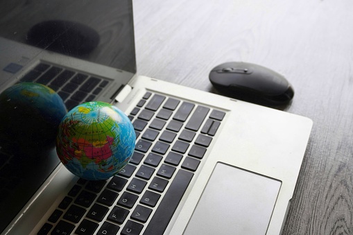 Close up image of globe, laptop keyboard and computer mouse. Internet, globalization and technology concept