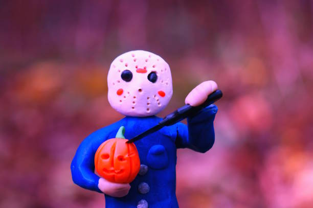 toy jason in a hockey mask and a pumpkin in his hand threatens with a knife. - friday the 13th imagens e fotografias de stock