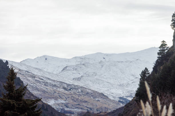istock Snowy hills through a valley 1607045860