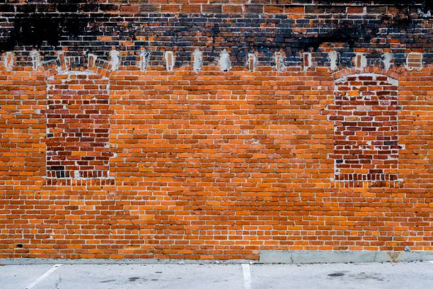 istock Brick wall with holes for the windows closed with bricks 1607054738