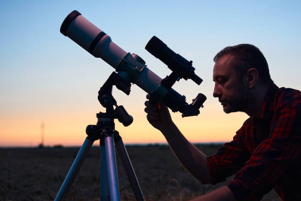 istock Astronomer looking at night sky with a telescope. 1607060531