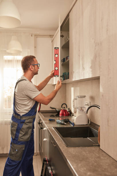 istock Handyman fixing kitchen cabinets in the apartment. 1607072396
