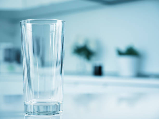 istock Clean water in glass on table at the kitchen Blue tone 1607075740