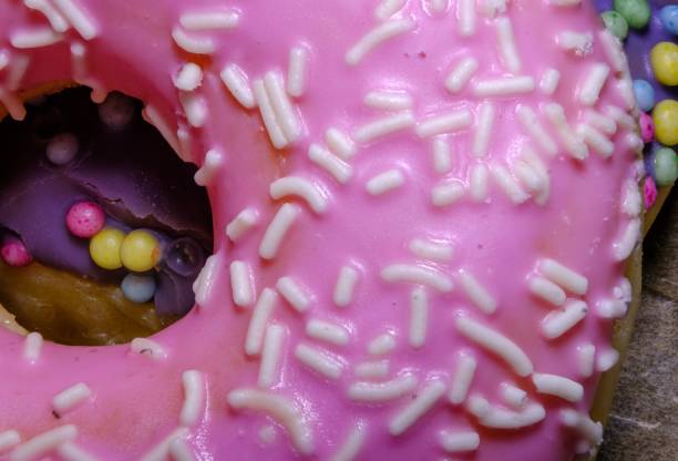 istock delicious pink donut floating on color background 1607104127