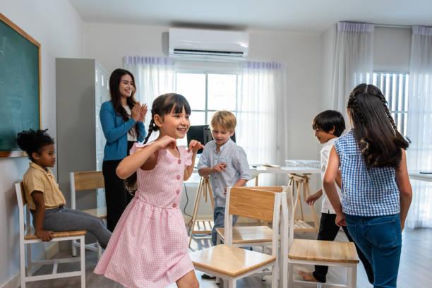istock Group of student learn with teacher in classroom at elementary school. Attractive beautiful female instructor master explain and educate young children with happiness and fun activity at kindergarten. 1607118377