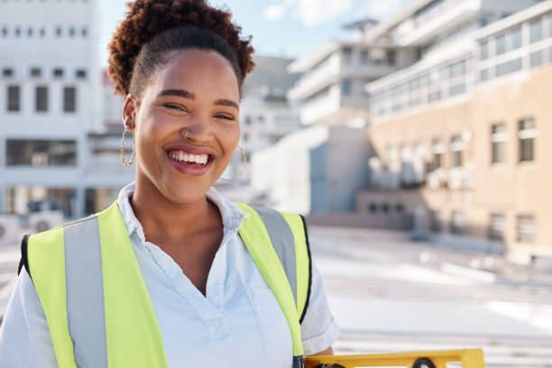 istock Smile, woman builder and portrait on site for construction, building or infrastructure maintenance in the city. Happy, industrial and an African architect, engineer or contractor in safety or labor 1607124359