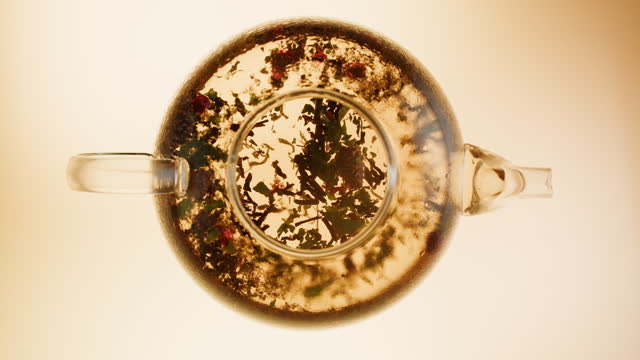 Black tea top view. Fresh hot herbal tea, healthy morning, detox drink on orange background.