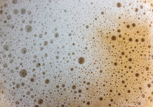 coffee foam with milk close-up. fresh coffee, morning drink, background cream with bubbles. cappuccino or latte - dark chocolate audio imagens e fotografias de stock