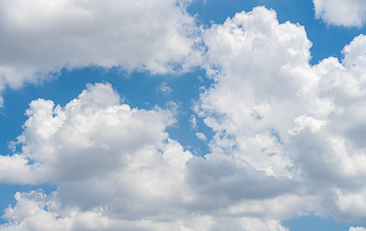 Beautiful view of blue sky with clouds. Beautiful shapes, partly cloudy. Colorful sunset. Natural sky background texture, beautiful color. Bright landscape in the blue sky. Selective focus