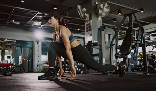 Active woman stretching in gym.