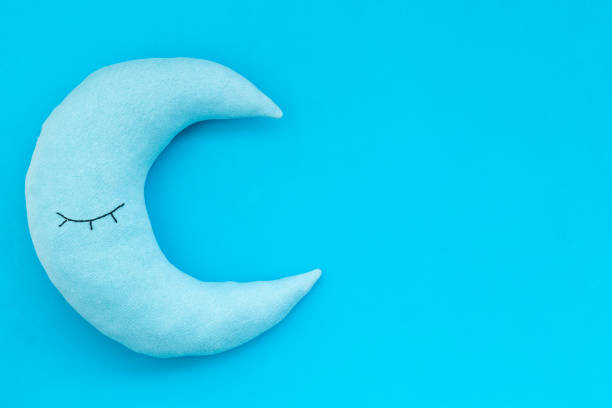 Soft pillow in shape of moon. Bedding for good sleep and rest.