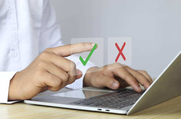 istock Businessman points out yes or no or corrects errors to make customer satisfied on green, red screen. 1607190287