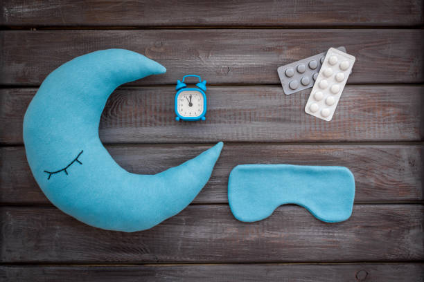 istock Insomnia concept with sleeping pills and moon pillow 1607194053