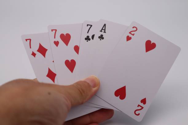 istock Three of a kind completed in poker 1607194590