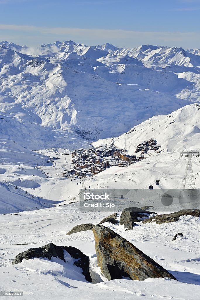 View on Val Thorens View on Val Thorens in the Trois Vallees skiing area. A Gondola is moving skiers up the mountain on the right, while people are skiing on the piste below. Beauty In Nature Stock Photo
