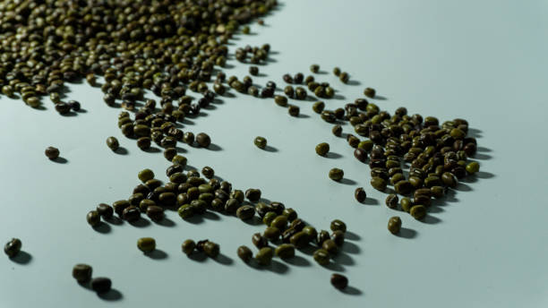 istock Mung bean heap close-up on a white. Isolated on white background 1607207446