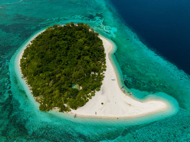 istock Tropical Island in Camiguin, Philippines. Mantigue Island. 1607213116