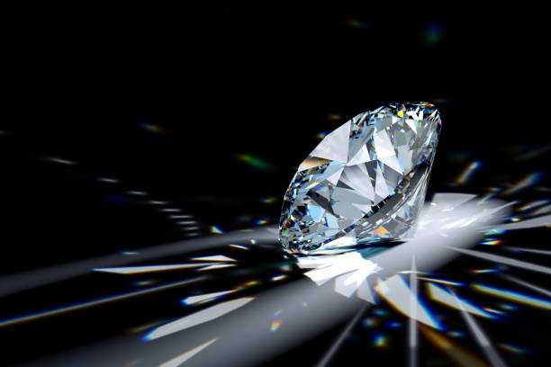 istock Round brilliant diamond in spotlight with colorful refraction rays. 1607218914