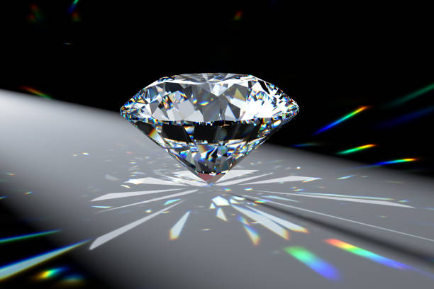 istock Round brilliant diamond in spotlight with colorful refraction rays. 1607218916