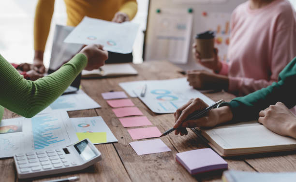 istock Business people meeting explaining the financial graph data and marketing plan. Group of business people at meeting assessment the state of business investment and marketing. 1607229444