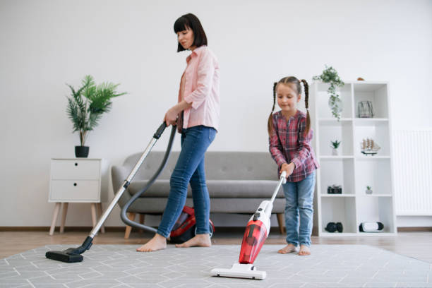 istock Mother and kid cleaning home with electrical appliances 1607275959