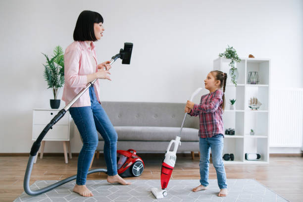 istock Mother and daughter having fun while doing household duties 1607276490