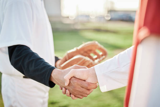 istock People, sports or handshake for team greeting, introduction or respect on baseball field together. Zoom of men shaking hands in softball match or game in competition, training or workout exercise 1607294870