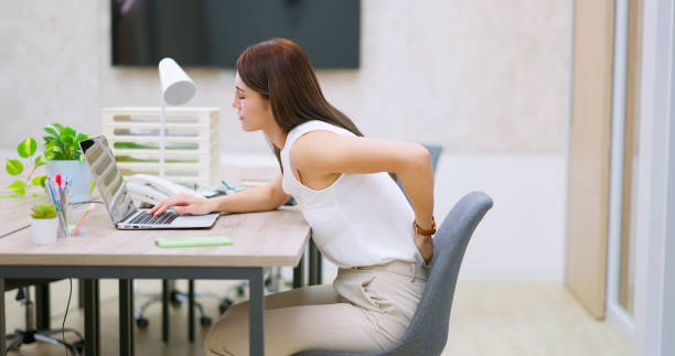 woman has shoulder pain pain at work - side view asian business woman slouch suffer from back and shoulder ache in office bad posture stock pictures, royalty-free photos & images
