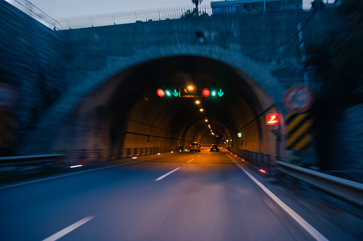 Blurred photo of the entrance to the tunnel. More truly atmospheric photo of a road in a mountainous area. Tunnel through the mountain