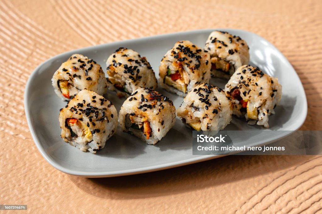 Assorted Sushi Roll sushi is a Japanese dish of prepared vinegared rice, usually with some sugar and salt, accompanied by a variety of ingredients such as seafood, often raw and vegetables. Inside Out Sushi Roll Stock Photo