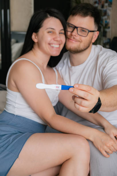 istock happy couple looking at positive pregnancy test 1607316853
