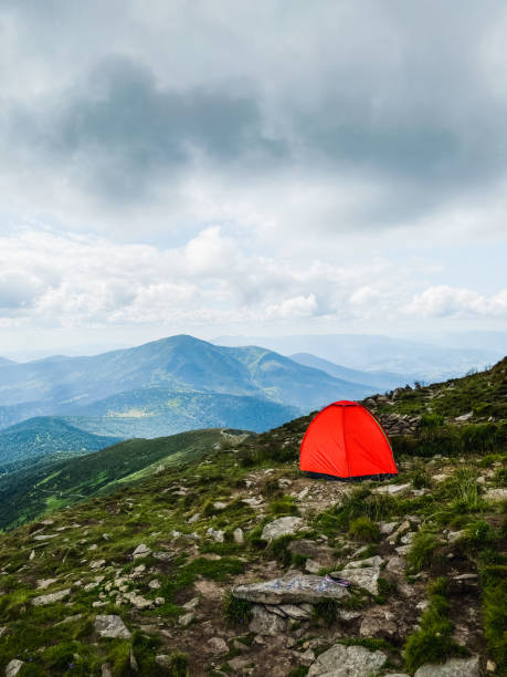 istock Bright tent on the top of the mountain 1607317372