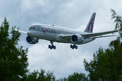 Qatar Airways Boeing 787 Dreamliner coming in to land between the trees at Oslo Airport, Gardermoen, Norway