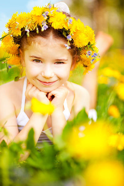 istock Little girl lying among dandelions 160734072