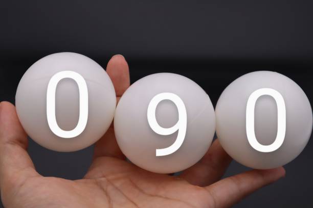 A person holding a ball with 090 written on it